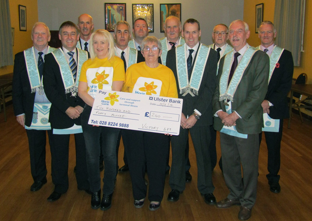 Representatives from Marie Curie pictured receiving a cheque for £240 from brethren of Victory Masonic Lodge 689, Omagh