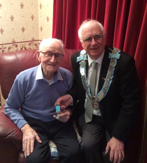 Bro James Warnock receiving a Tyrone and Fermanagh 150 year jewel from PGM RWBro Maurice Lee